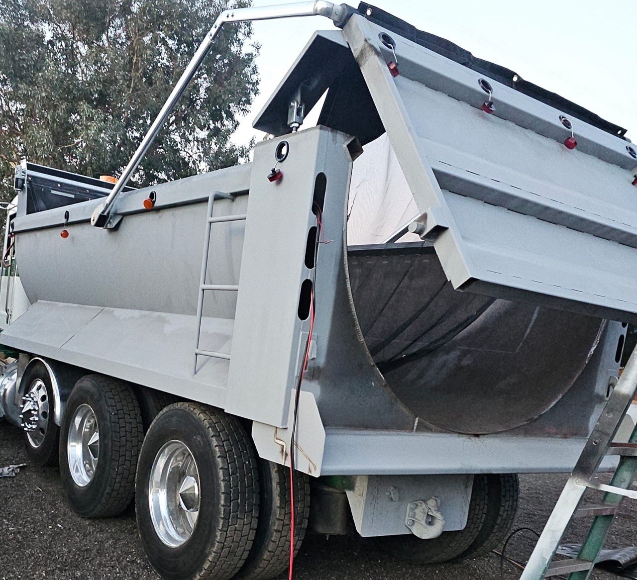 Custom gray dump truck with tailgate open by The Welding Brothers, Perris CA