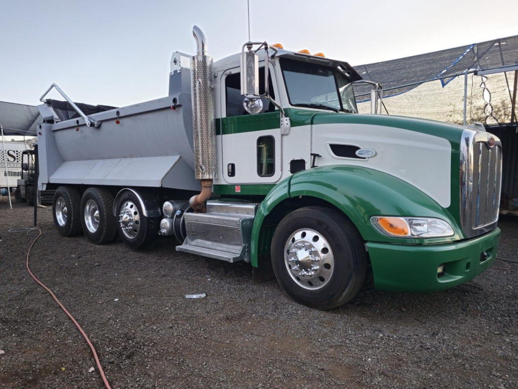 Heavy-duty dump truck on road — example of dump body fabrication work